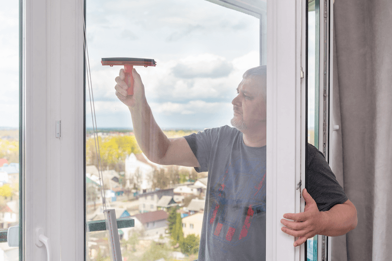 man cleaning window